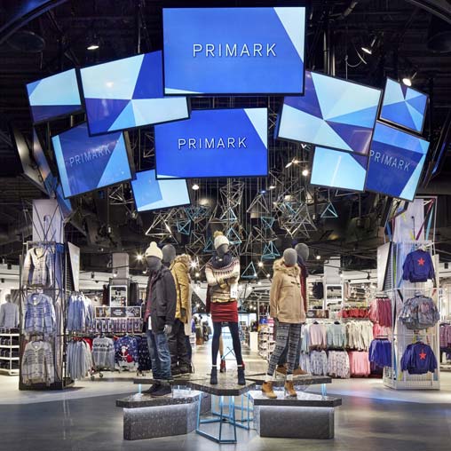 A group of people standing in front of a display of products.