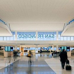 A person with a suitcase in an airport.