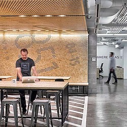 A man standing next to a table.