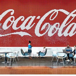 A person standing in front of a wall with graffiti.