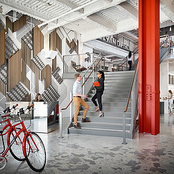 A man and woman walking down a flight of stairs.
