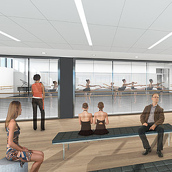 A group of people sitting on a bench in a room with windows.