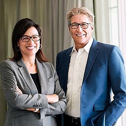 A man and a woman smiling.