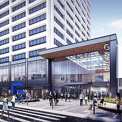 A group of people walking outside of a building.