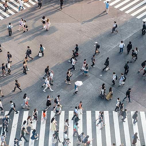 A group of people walking on a street.