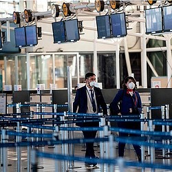 A man and woman wearing masks.