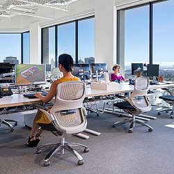 A group of people sitting at desks in an office.