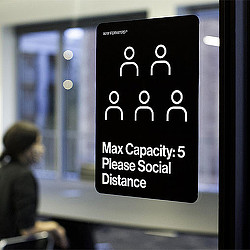 A sign on a glass wall.