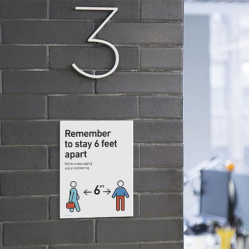 A sign on a brick wall.