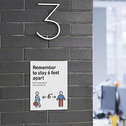 A sign on a brick wall.