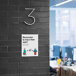 A sign on a brick wall.