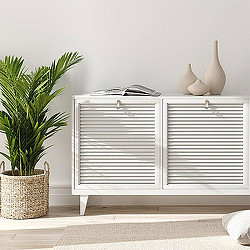 A white radiator with a plant and a basket on the side.