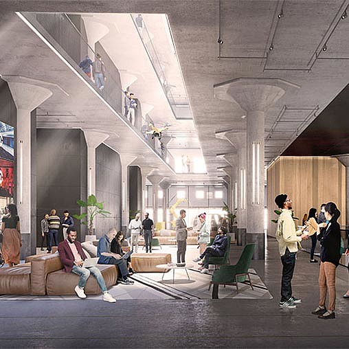 People sitting on benches in a building.