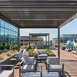 A couple of people sitting at a table outside.