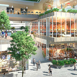 A building with glass walls and people walking around.