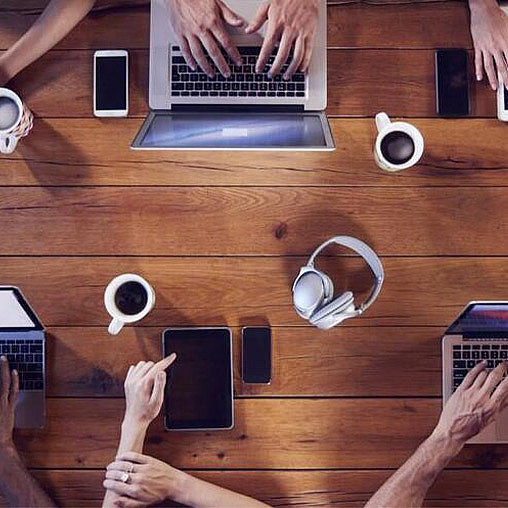 A group of hands holding cell phones.