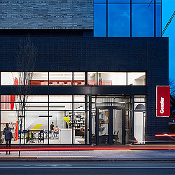 A building with a few people walking out front.