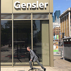 A person leaning against a glass door.