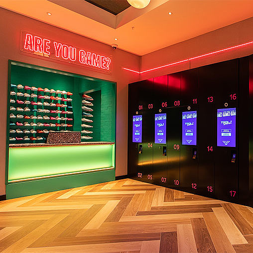 A bowling alley with a green wall.