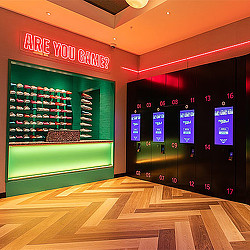 A bowling alley with a green wall.