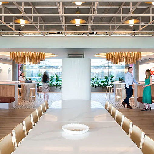 A large room with people and tables.