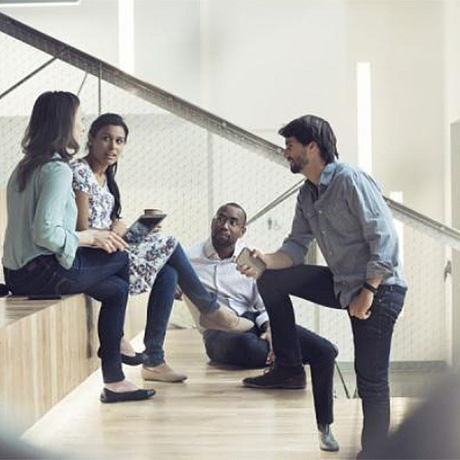 A group of people sitting on stairs.