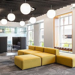 A room with a couch and a table with lights.
