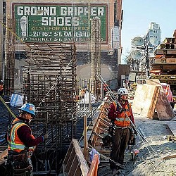 A few men in hardhats working on a construction site.