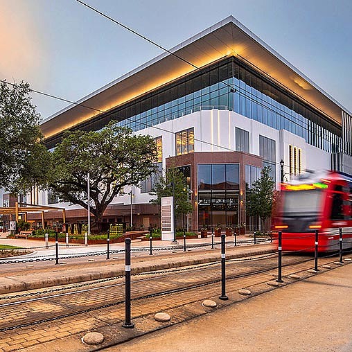 A train passing by a building.