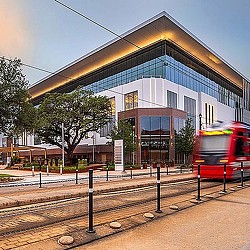 A train passing by a building.