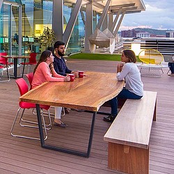 A group of people sitting at a table outside.