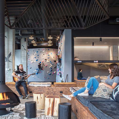 A person playing guitar in a room.