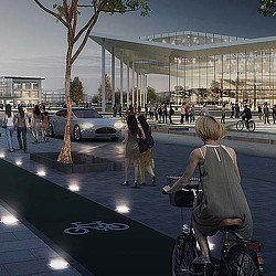 A person riding a bicycle on a street with people walking around.