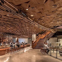 A group of people sitting at tables in a restaurant.