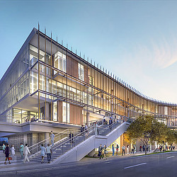 A building with stairs and people walking around.