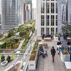 People walking on a walkway between buildings.