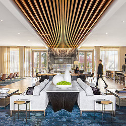 A room with a large glass ceiling and a large white couch.