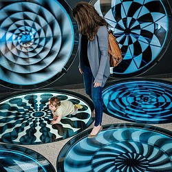 A woman looking at a man lying on the ground.