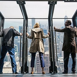 A group of people walking on a train.