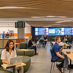 People sitting in a room with laptops.