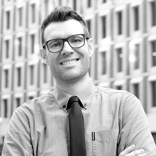 A man wearing glasses and a tie.