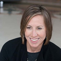 A close-up of a person smiling.