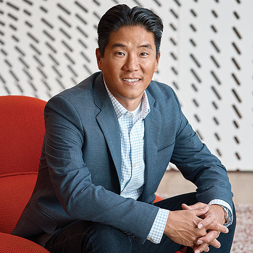 A person sitting on a red couch.