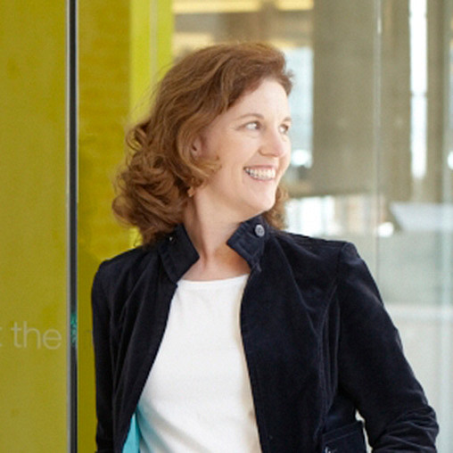 A person smiling in a black jacket.