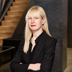 A woman in a black suit.