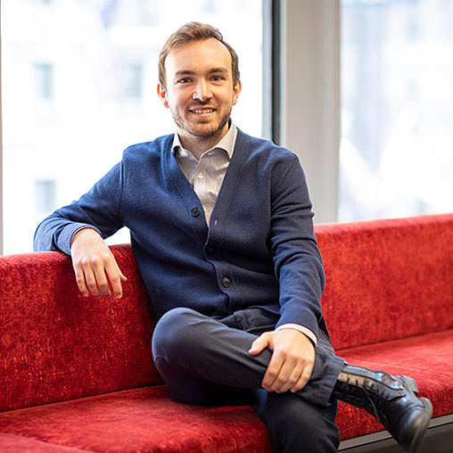 A person sitting on a red couch.