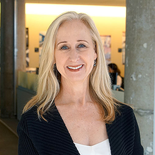 A woman smiling at the camera.