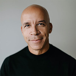 A bald man in a black shirt.