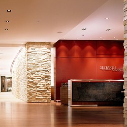 A room with a fireplace and a brick wall.