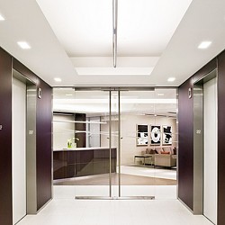 A glass walled room with a glass door and a glass wall.